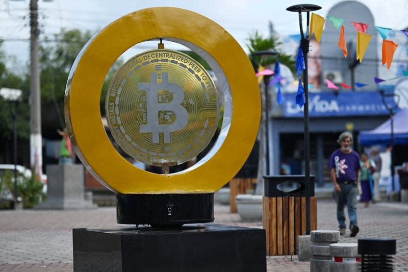 People walk past a bitcoin monument at Plaza Bitcoin in San Salvador on Sept. 4, 2024 [AFP]