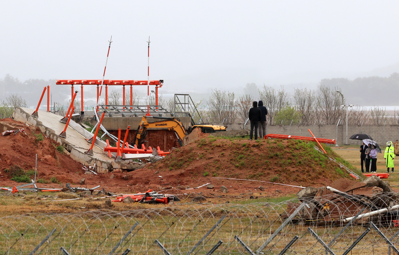 Officials from the Aviation and Railway Accident Investigation Board inspect localizers at the Muan International Airport in South Jeolla Province, the site of the deadly Jeju Air crash on Dec. 29, 2024, in this photo taken April 22. (Yonhap)