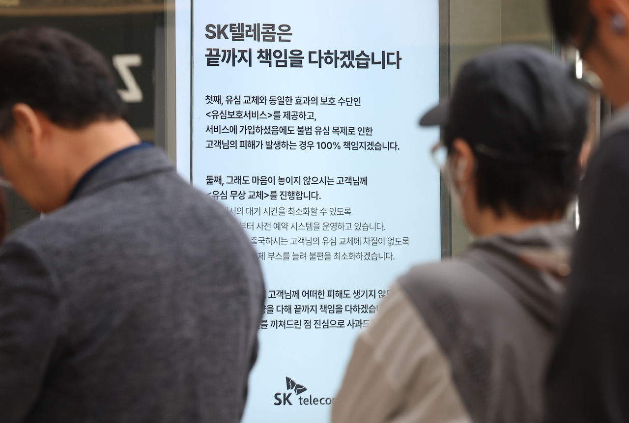 가입자 유심(USIM) 정보를 탈취당한 SK텔레콤이 유심 무료교체 서비스를 시작한 지 이틀째인 29일 서울 시내 한 SKT 대리점에 ‘SK텔레콤은 끝까지 책임을 다하겠습니다’라는 문구가 쓰여져 있다. [연합]