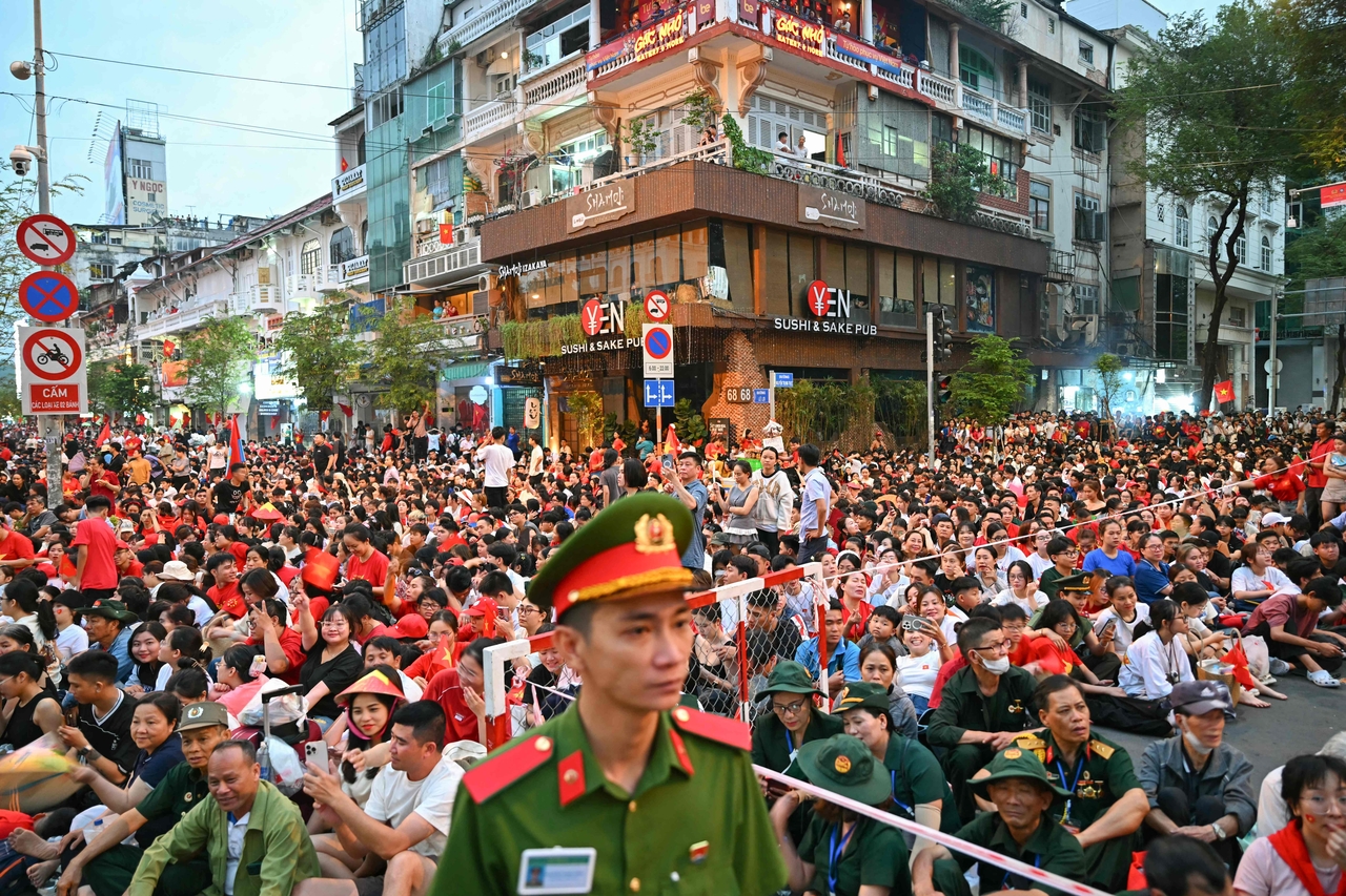 People gather ahead of a parade marking the 50th anniversary of the fall of Saigon and the end of the Vietnam War., in Ho Chi Minh City, Vietnam,  Wednesday.   (AFP-Yonhap)