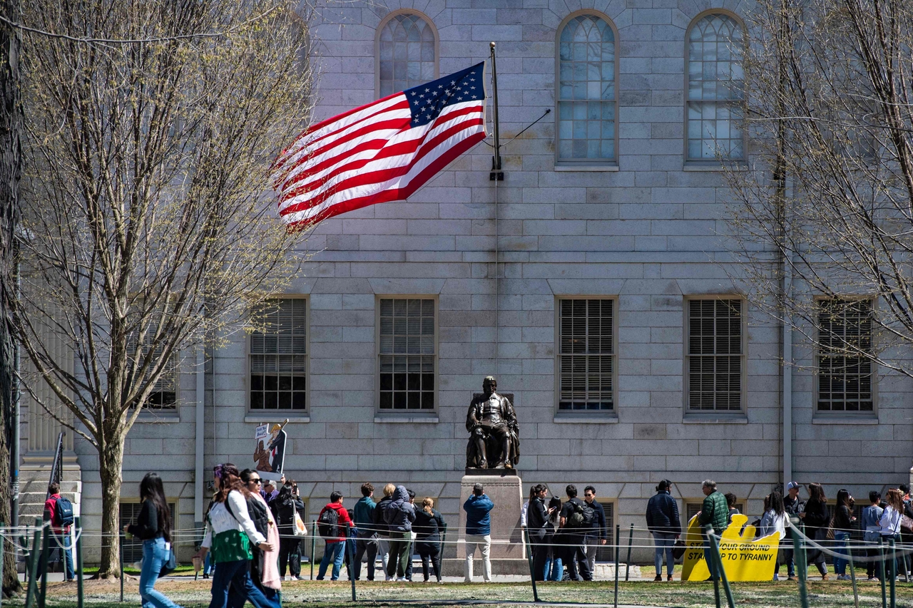 Demonstrators with signs stand around the John Harvard Statue in Harvard Yard, at Harvard University in Cambridge, Massachusetts, April 17.   (AFP-Yonhap)