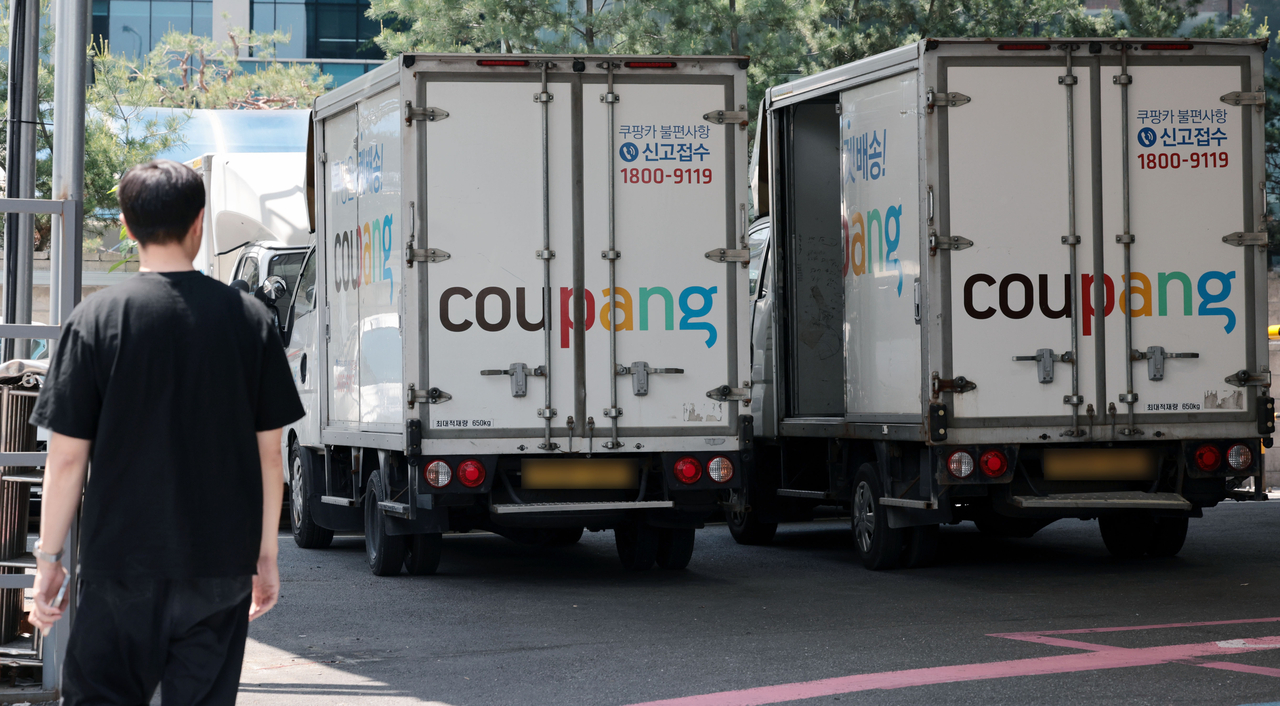 Coupang delivery trucks are parked next to each other. (Yonhap)