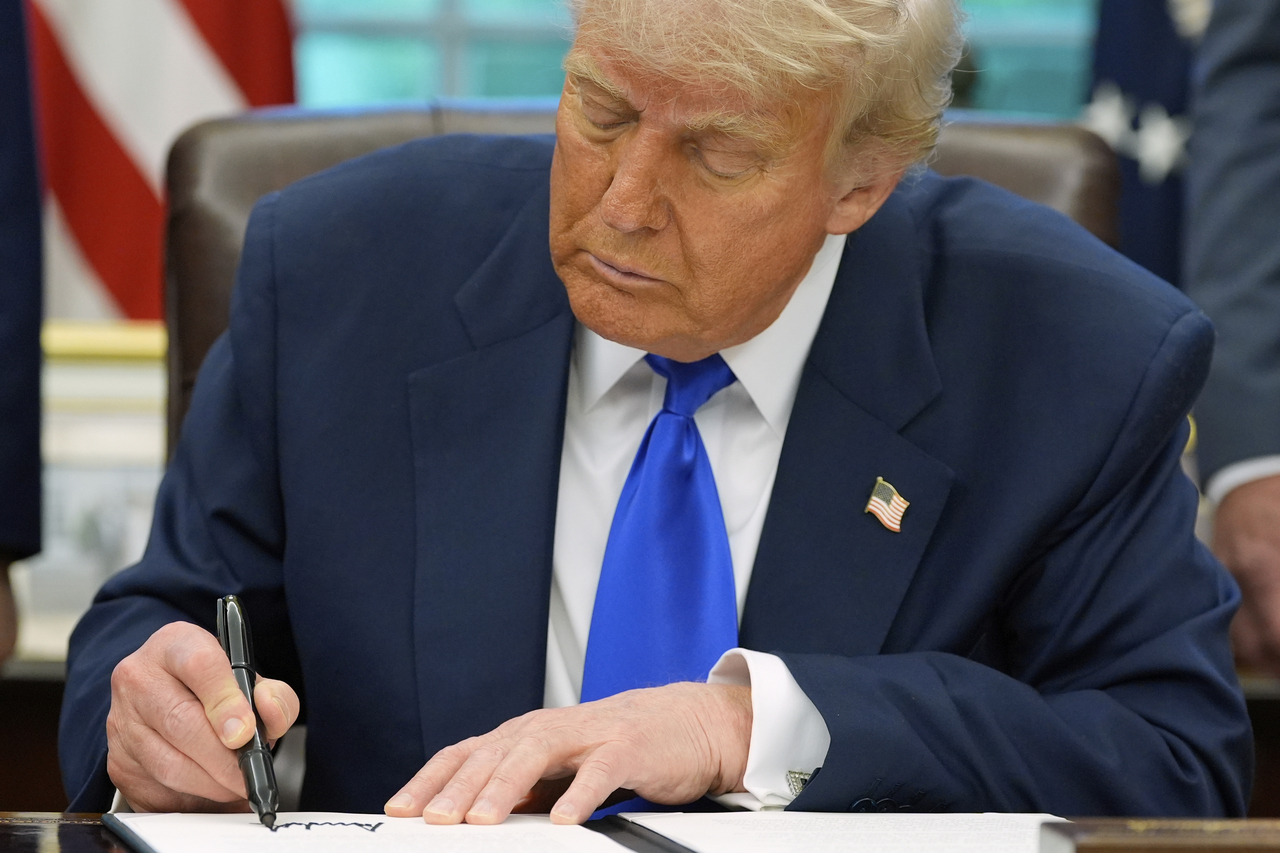 US President Donald Trump signs executive orders and proclamations in the Oval Office of the White House in Washington on Monday. (AP-Yonhap)