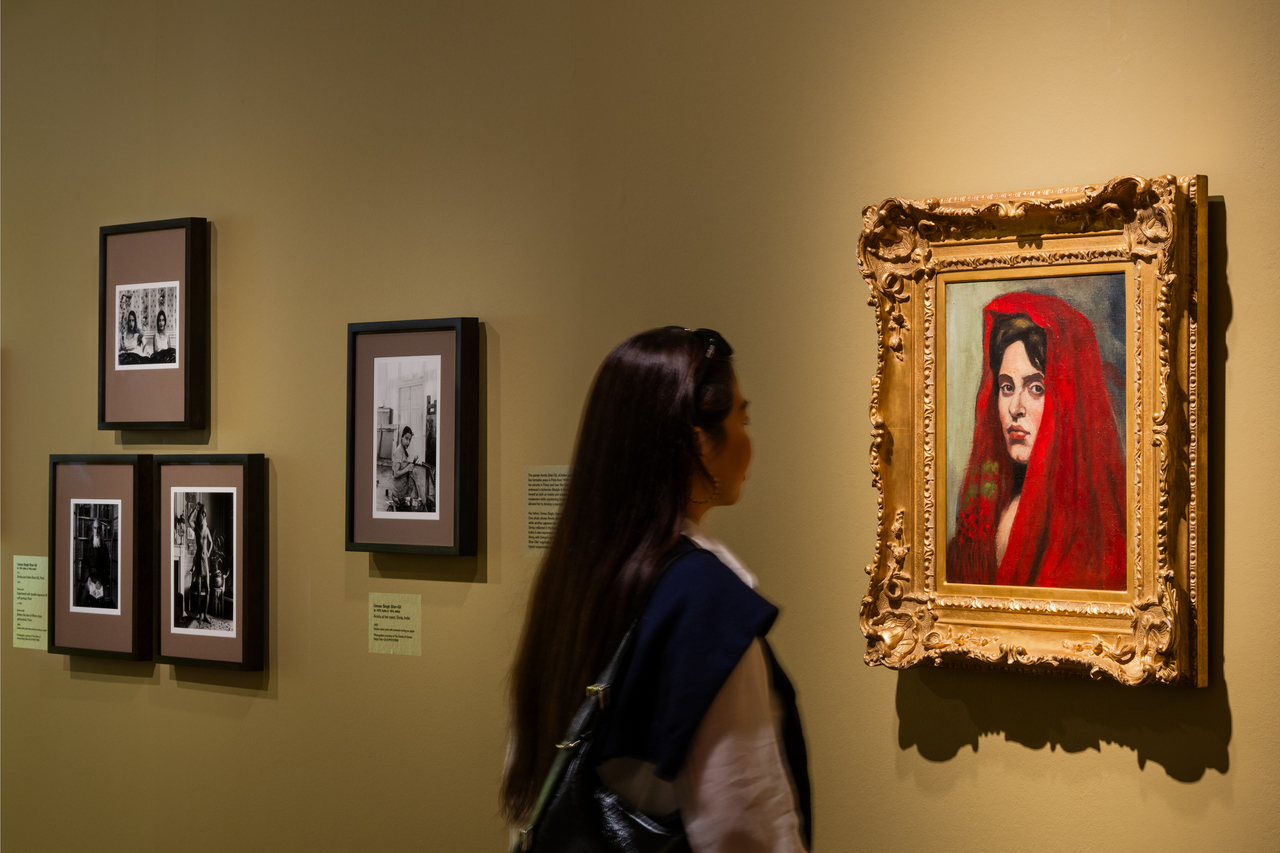 A visitor looks at Amrita Sher-Gil's "Woman Wearing Shawl" at National Gallery Singapore's exhibition "City of Others: Asian Artists in Paris, 1920s-1940s." (National Gallery Singapore)
