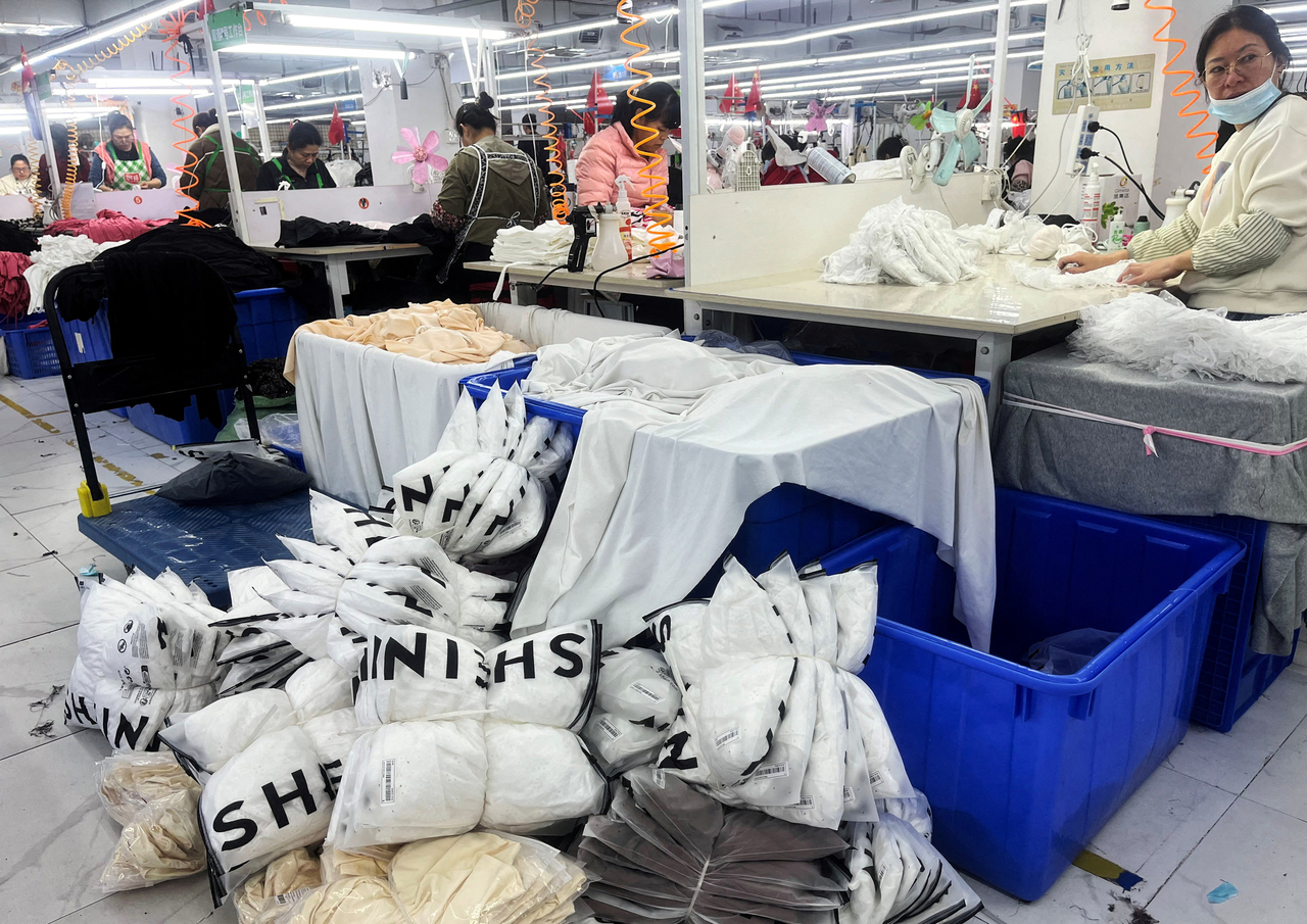 Workers work at a production line manufacturing clothing for Shein at a factory in Guangzhou, Guangdong province, China, April 1.   Reuters-Yonhap