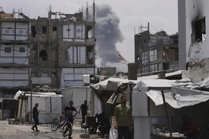 Gaza air strikes kill 94 as manhunt unfolds in West Bank