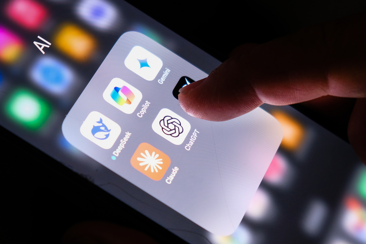 An iPhone user taps on the mobile application thumbnail of ChatGPT on their phone. (Getty Images Bank)
