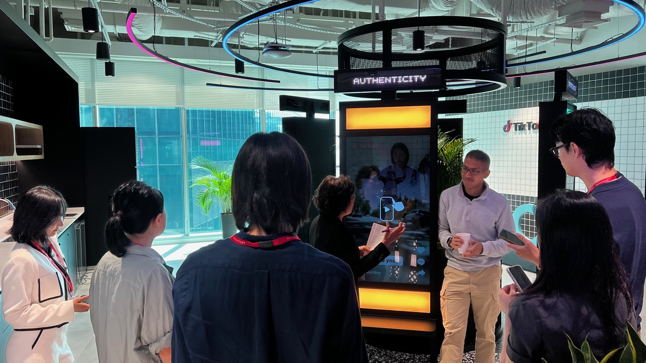 A TikTok official explains how moderation of harmful content is conducted at the Transparency and Accountability Center in Singapore, May 13. (TikTok)
