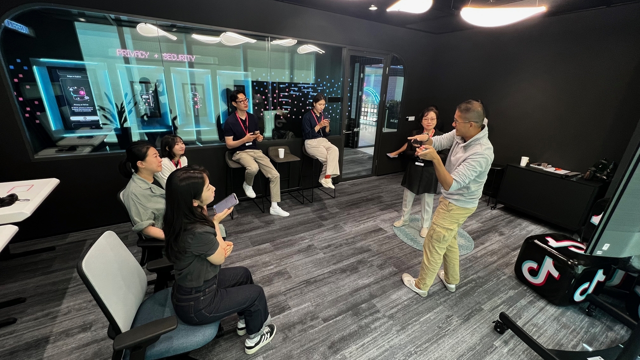 A TikTok official explains the moderation process to reporters at the Transparency and Accountability Center in Singapore, May 13. (TikTok)