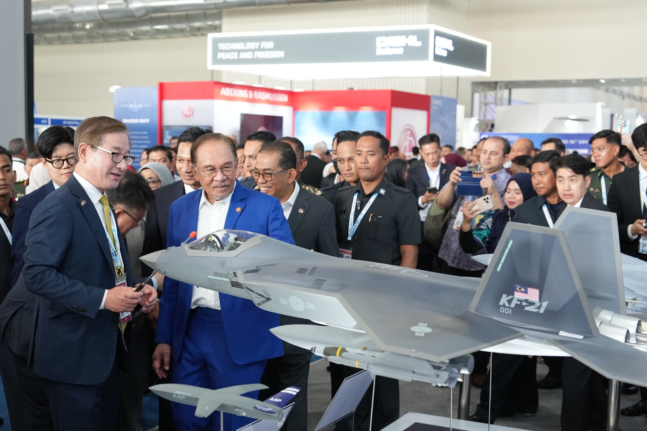 KAI CEO Kang Goo-young (left) briefs Malaysian Prime Minister Anwar Ibrahim (second from left) on the KF-21 and FA-50M fighter jets at the LIMA 2025 defense exhibition in Langkawi, Malaysia, Tuesday. (Korea Aerospace Industries)