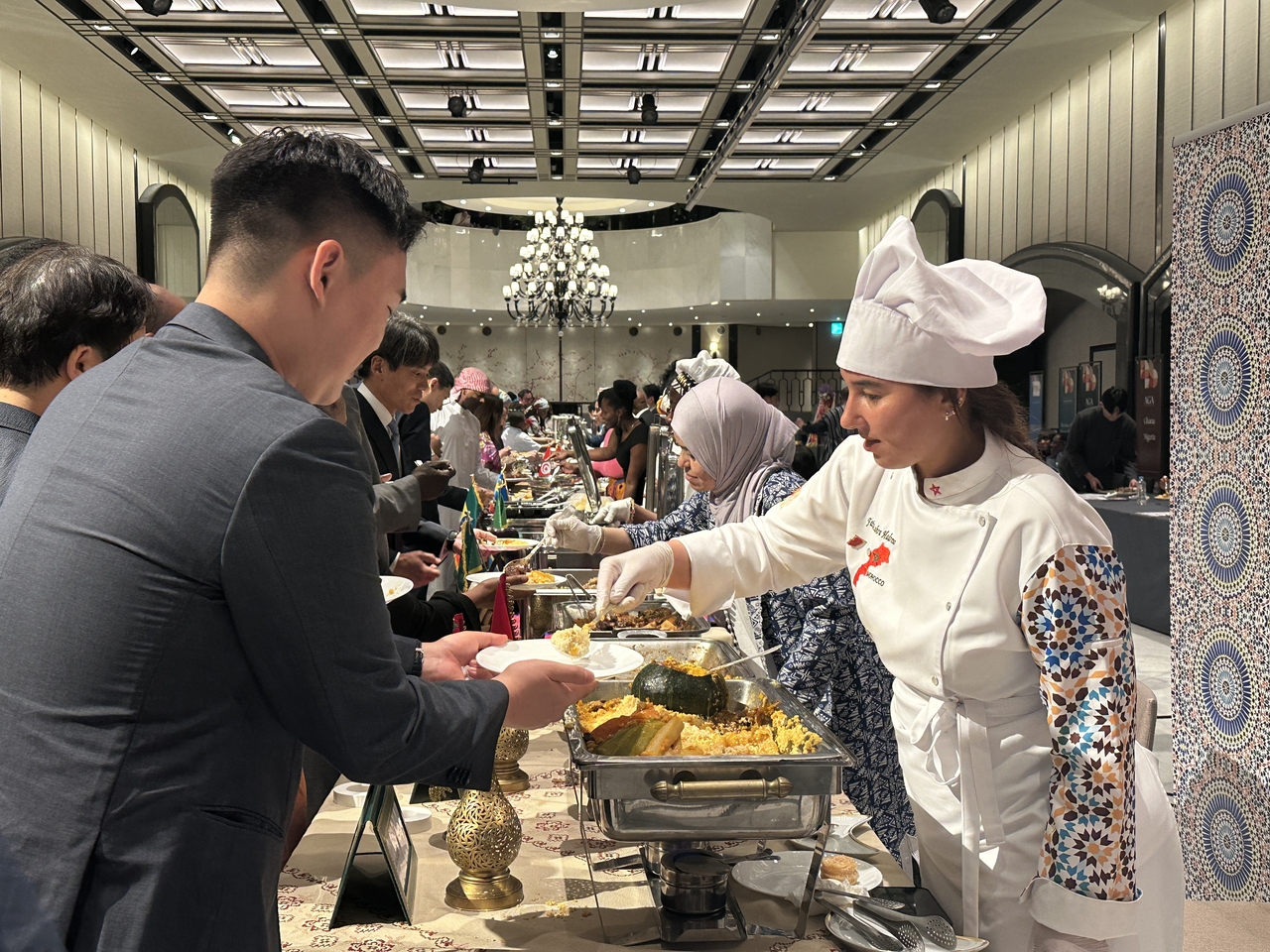 A participant receives a Moroccan traditional dish during the Africa Day 2025 Korea-Africa Business Forum held at the Grand Hyatt Seoul, Wednesday. (Lee Jung-joo/The Korea Herald)