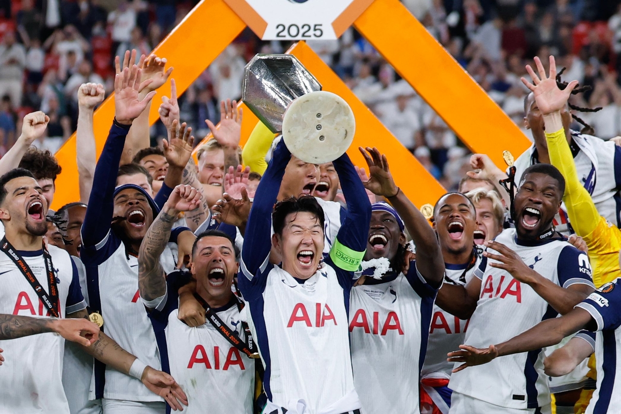 Tottenham Hotspur's South Korean forward Son Heung-min raises the trophy as he celebrates with teammates winning the UEFA Europa League final football match between Tottenham Hotspur and Manchester United at San Mames stadium in Bilbao on May 21. (AFP)
