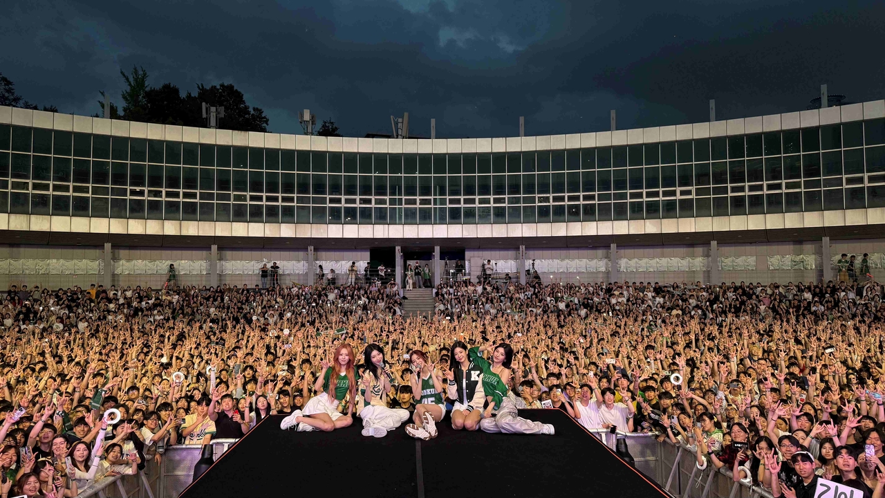 Itzy performing on stage at Konkuk University spring festival in Seoul with fan crowd