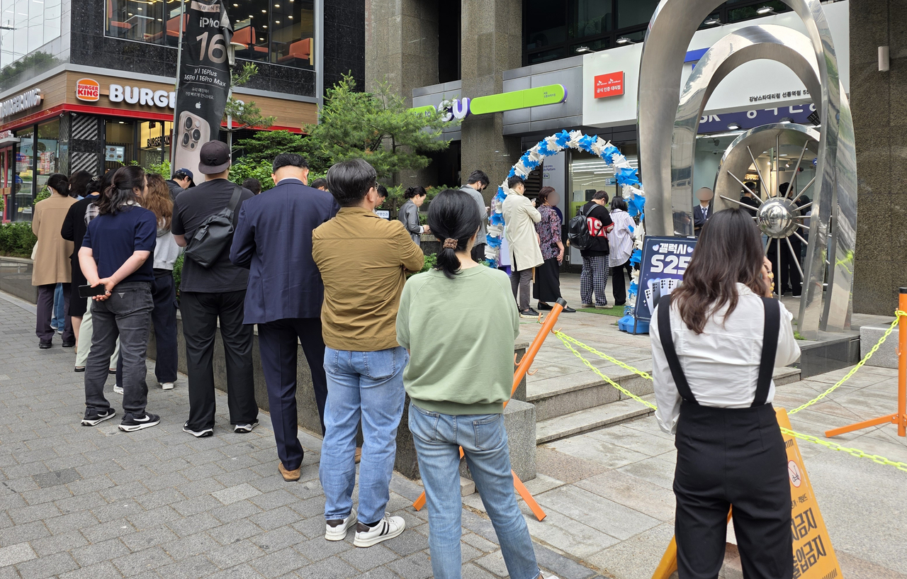 Customers of SK Telecom line up on May 20 outside a branch in Seoul to receive replacement SIM cards, after a large-scale data breach revealed in April is thought to have resulted in SIM-related data of over 20 million subscribers. (Yonhap)