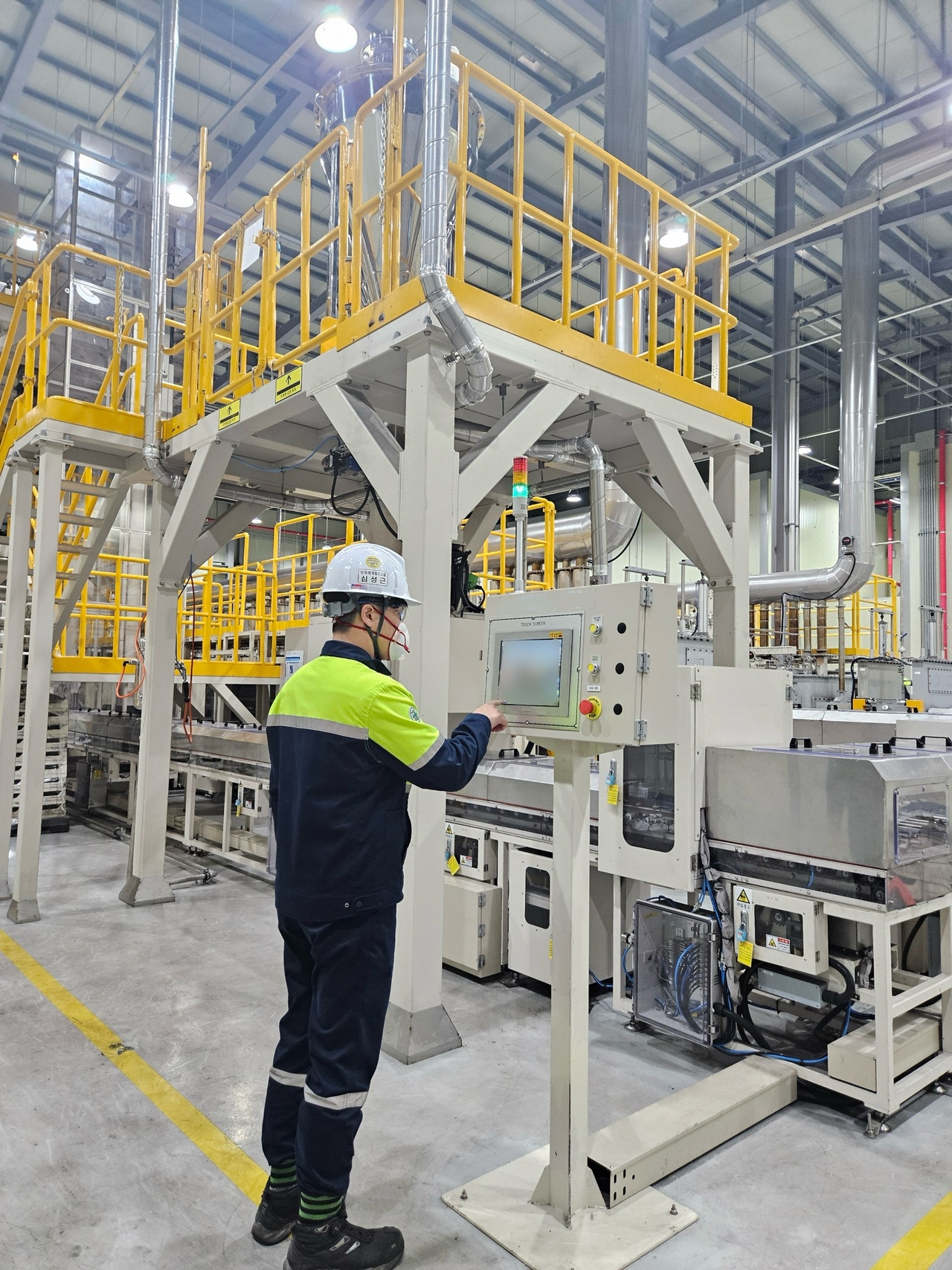 An engineer at Posco Future M inspects the production line for lithium manganese-rich cathode materials at the Sejong Technology Research Center pilot plant." (Posco Future M)