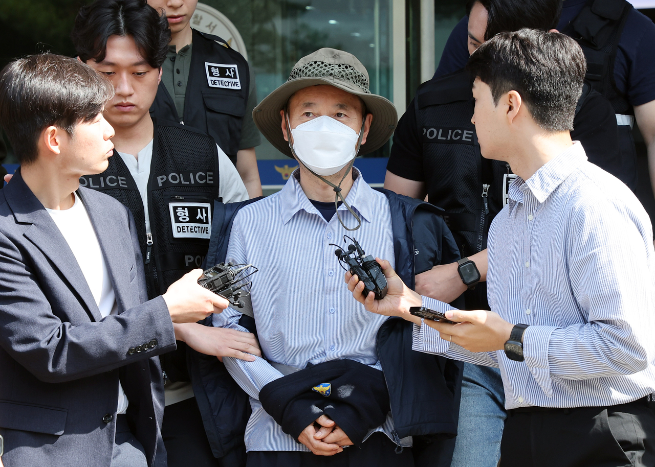 A Chinese national of Korean ethnicity in his 50s, identified as Cha Cheol-nam (center), leaves a police station in Siheung, just southwest of Seoul, on May 21, 2025, to attend a court hearing to review whether a warrant will be granted for his arrest for allegedly killing two people on May 17 and seriously injuring two others on May 19. (Yonhap)