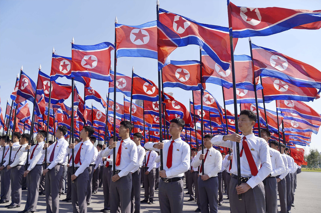 People line up with North Korean flags in Pyongyang on April 25 to celebrate the 93rd anniversary of the founding of the Korean People's Revolutionary Army.  (Getty Images)