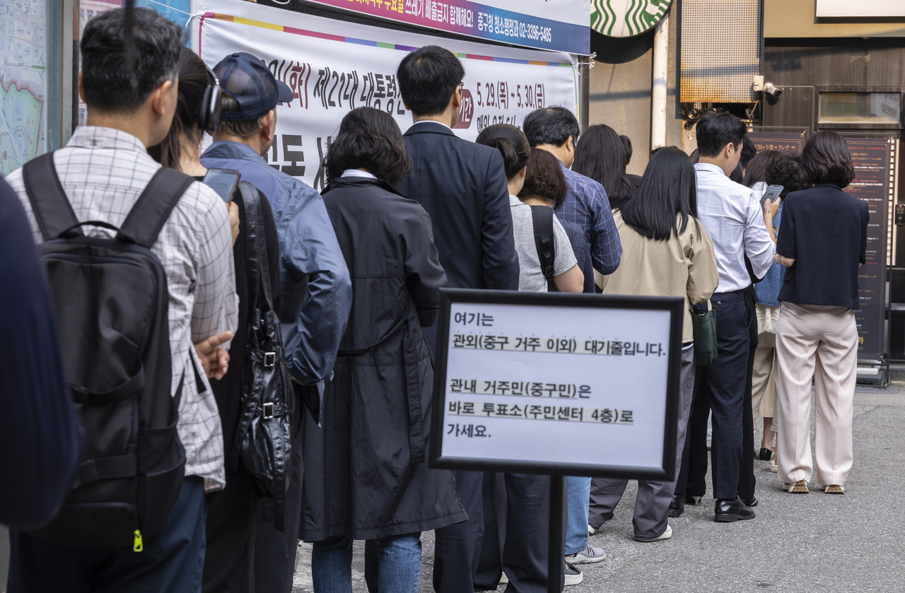 On the second and final day of advance voting for the June 3 presidential election, voters stand in line at a polling station set up at the Sogong-dong Community Center in Jongno-gu, Seoul, Friday. (Yonhap)