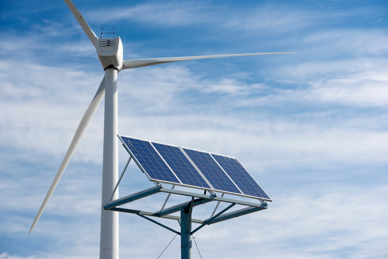 Windmill and photovoltaic panel for energy production (123rf)
