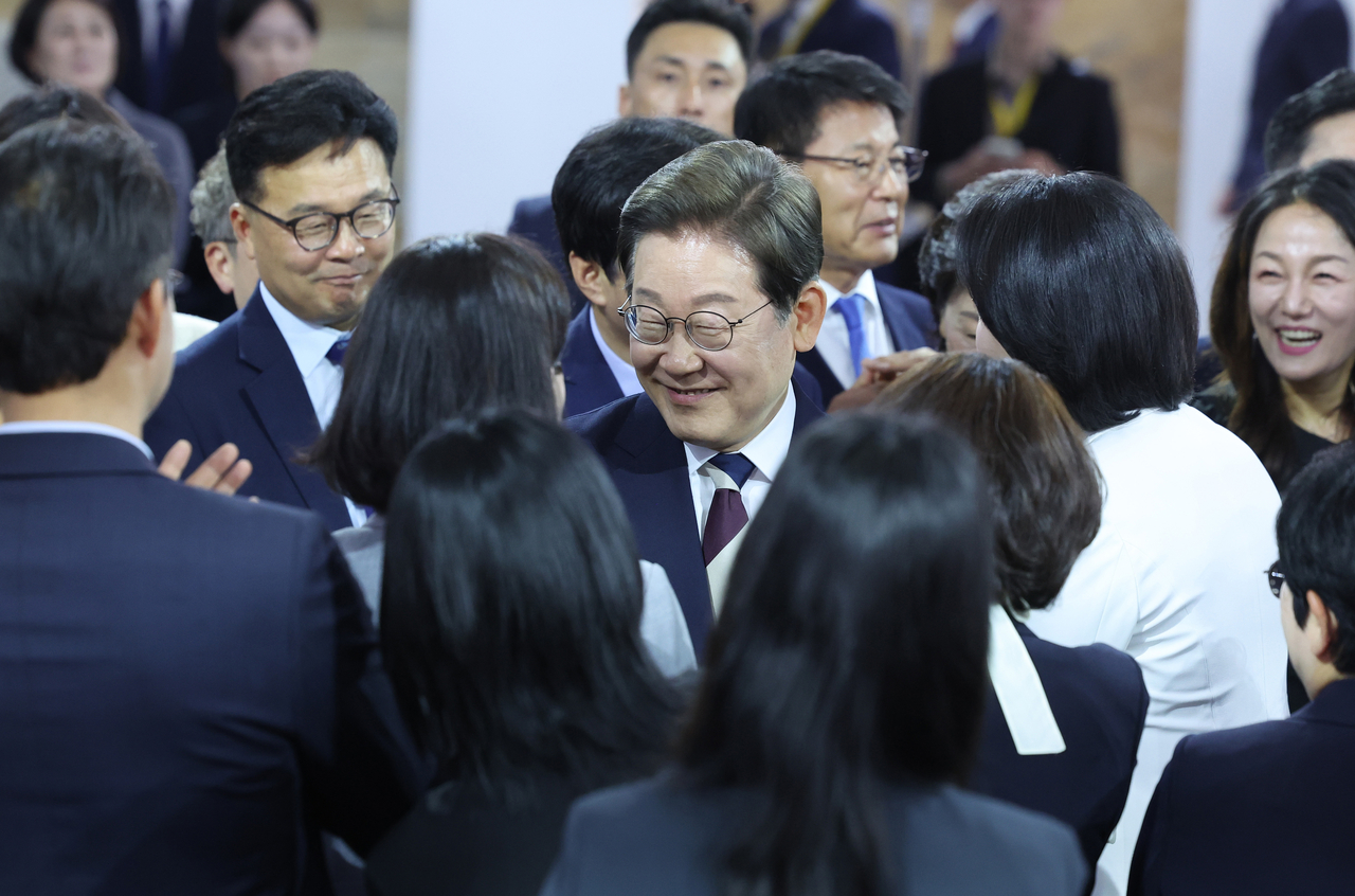 South Korean President Lee Jae-myung (center) is greeted by Democratic Party of Korea lawmakers after his inauguration speech Wednesday. (National Assembly press corps)