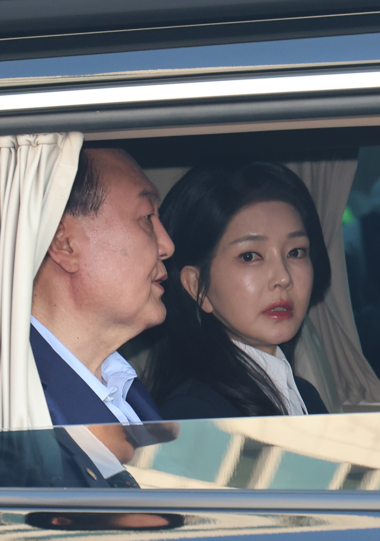 Kim Keon Hee (right) leaves the official presidential office in Hannam-dong, Seoul, with her husband Yoon Suk Yeol on May 11, after Yoon's expulsion from the presidency was confirmed by the Constitutional Court. (Im Se-jun/The Korea Herald)