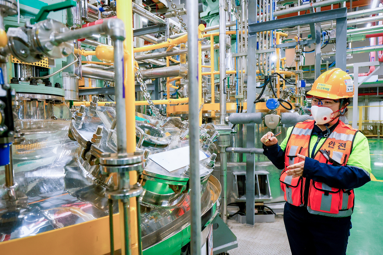 A Posco Future M official explains the manufacturing process in the company's precursor plant in Gwangyang, South Jeolla Province, Tuesday. (Posco Future M)