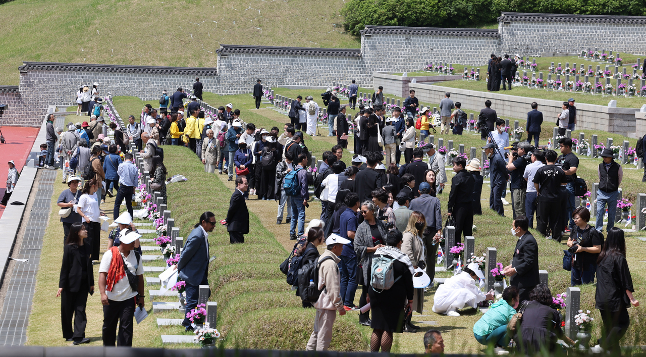 Visitors pay respects at the May 18th National Cemetery in Gwangju on May 18. (Yonhap)
