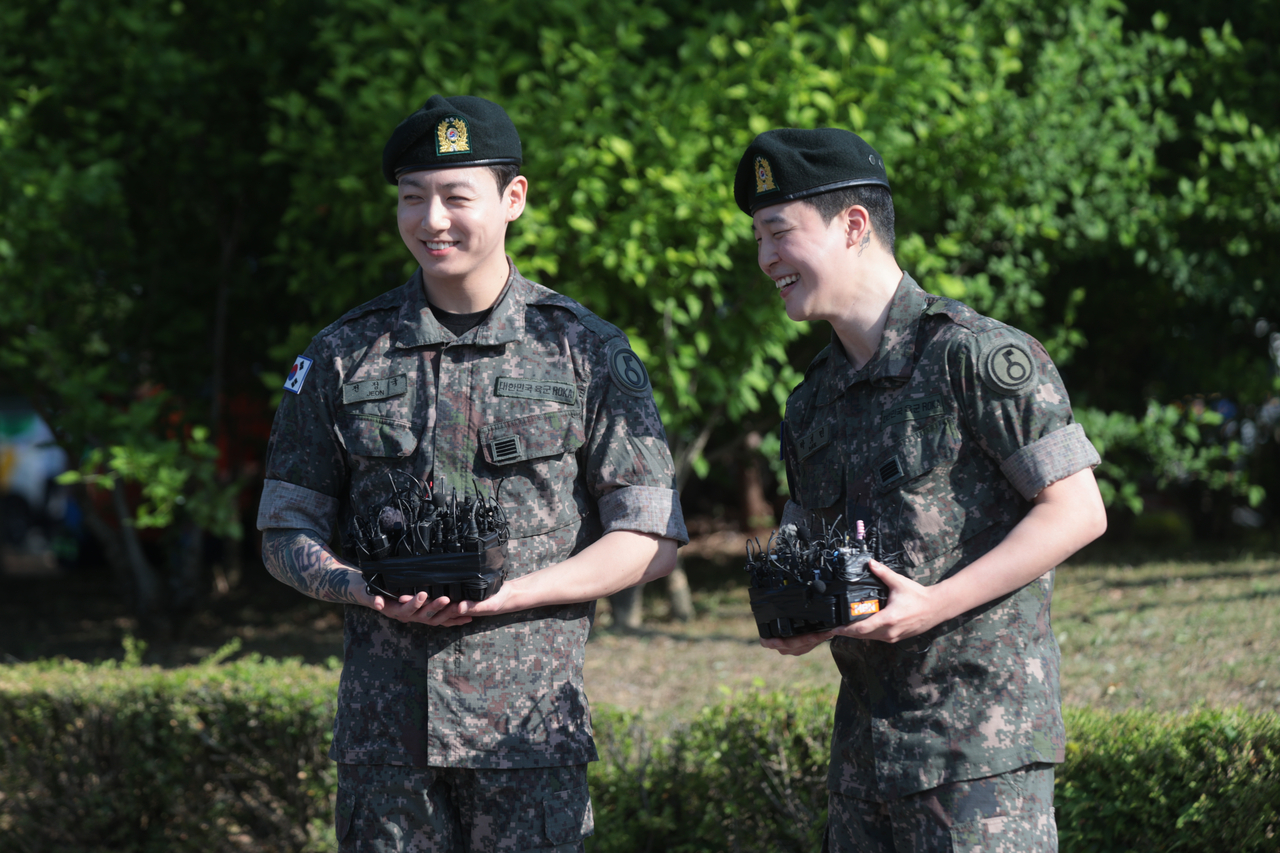 BTS members Jimin (right) and Jungkook smile as they share their thoughts on completing their military service at Yeoncheon Public Stadium in Yeoncheon, Gyeonggi Province, Wednesday. (Yonhap)