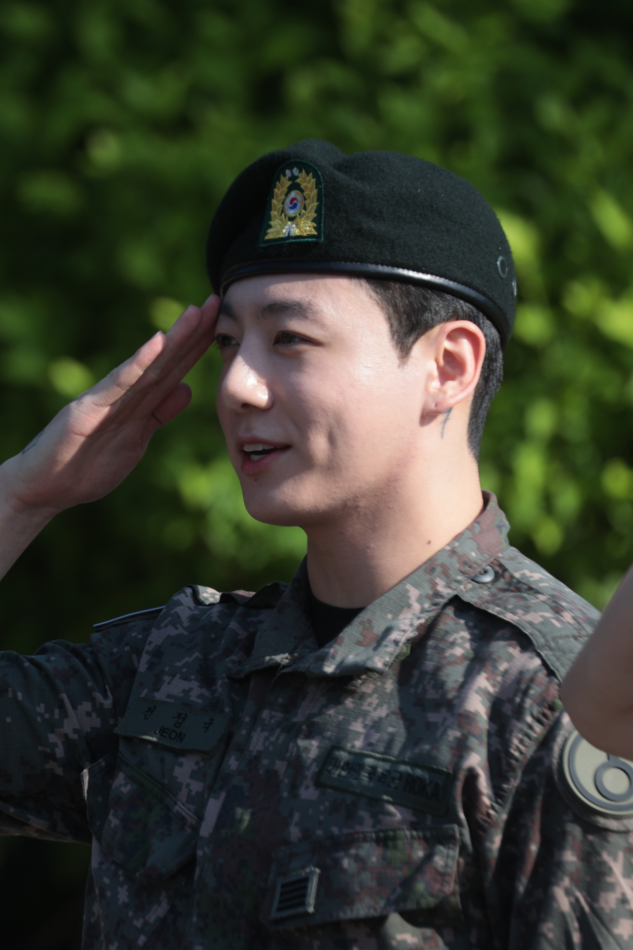 Jungkook of BTS salutes fans at Yeoncheon Public Stadium in Yeoncheon, Gyeonggi Province, Wednesday, after completing his mandatory military service. (Yonhap)