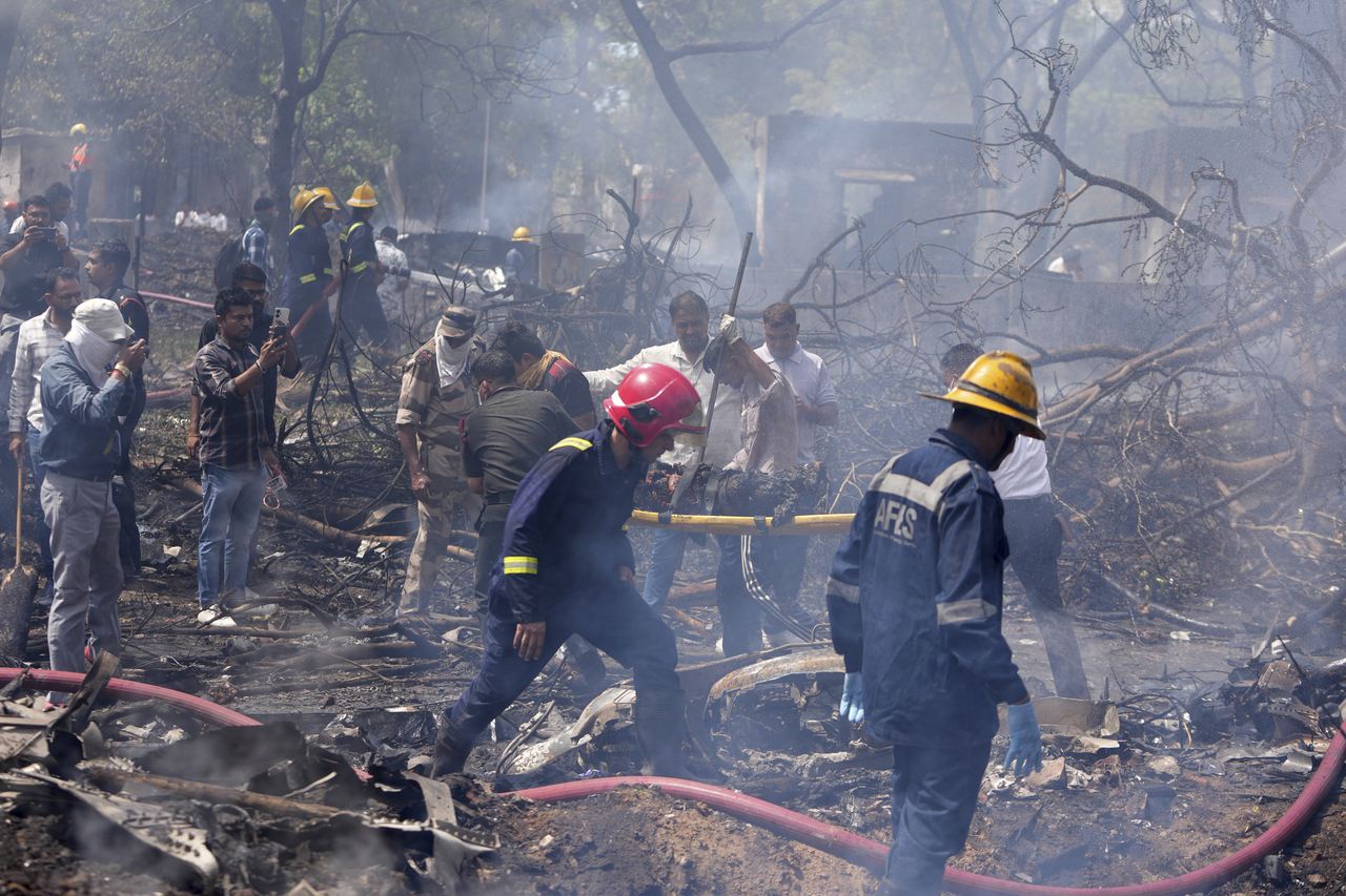 Firefighters work at the site of an airplane that crashed in India's northwestern city of Ahmedabad in Gujarat state, Thursday, June12, 2025. (AP-Yonhap)