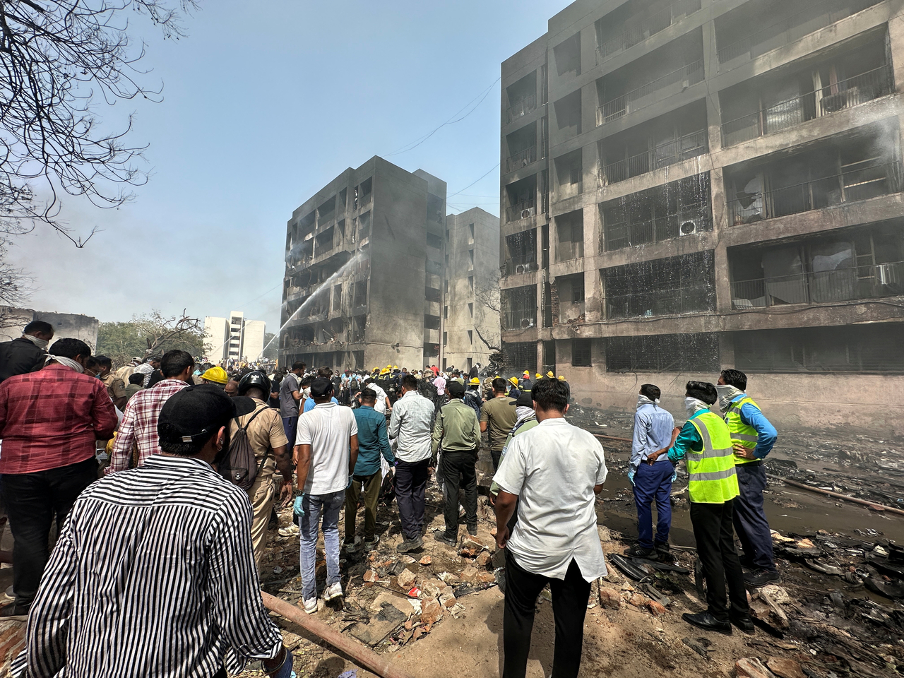 People gather near the site where an Air India plane crashed in Ahmedabad, India, June 12, 2025. (Reuters-Yonhap)