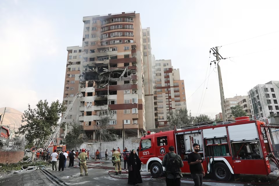 Firefighters work at the scene of a damaged building in the aftermath of Israeli strikes, in Tehran, Iran, June 13, 2025. (Reuters)