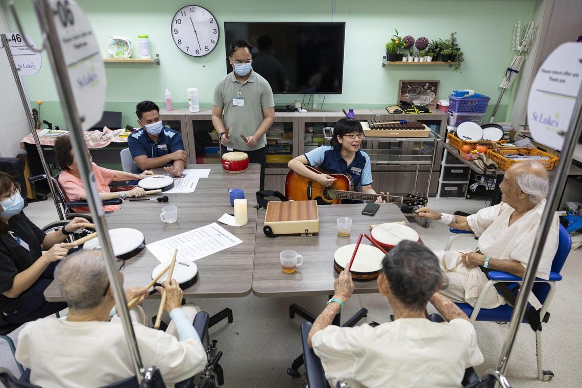 Bakti Khair (center) conducts a music therapy session with dementia patients at St. Luke’s Hospital.    (Straights Times)