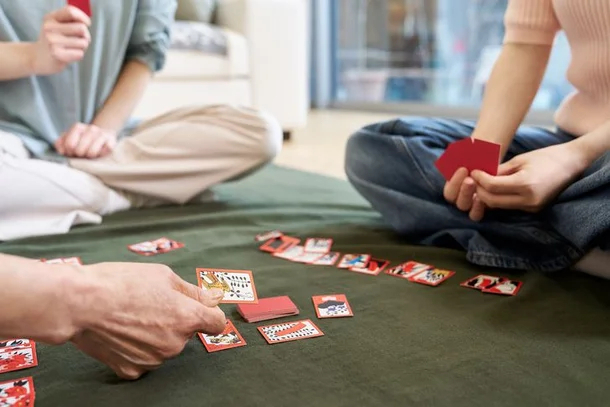 A group of people play hwatu, or Go-Stop, Korea’s traditional card game. (Getty Image)