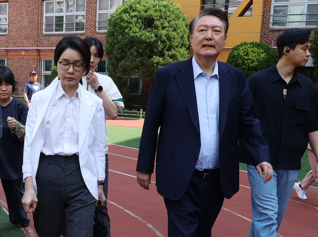 In this file photo, former President Yoon Suk Yeol (right) and first lady Kim Keon Hee head to their vehicle after casting their votes at a polling station in Seoul on June 3. (Yonhap)