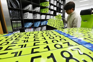 From stigma to status symbol: Lime-green plates lose bite after a year on the road