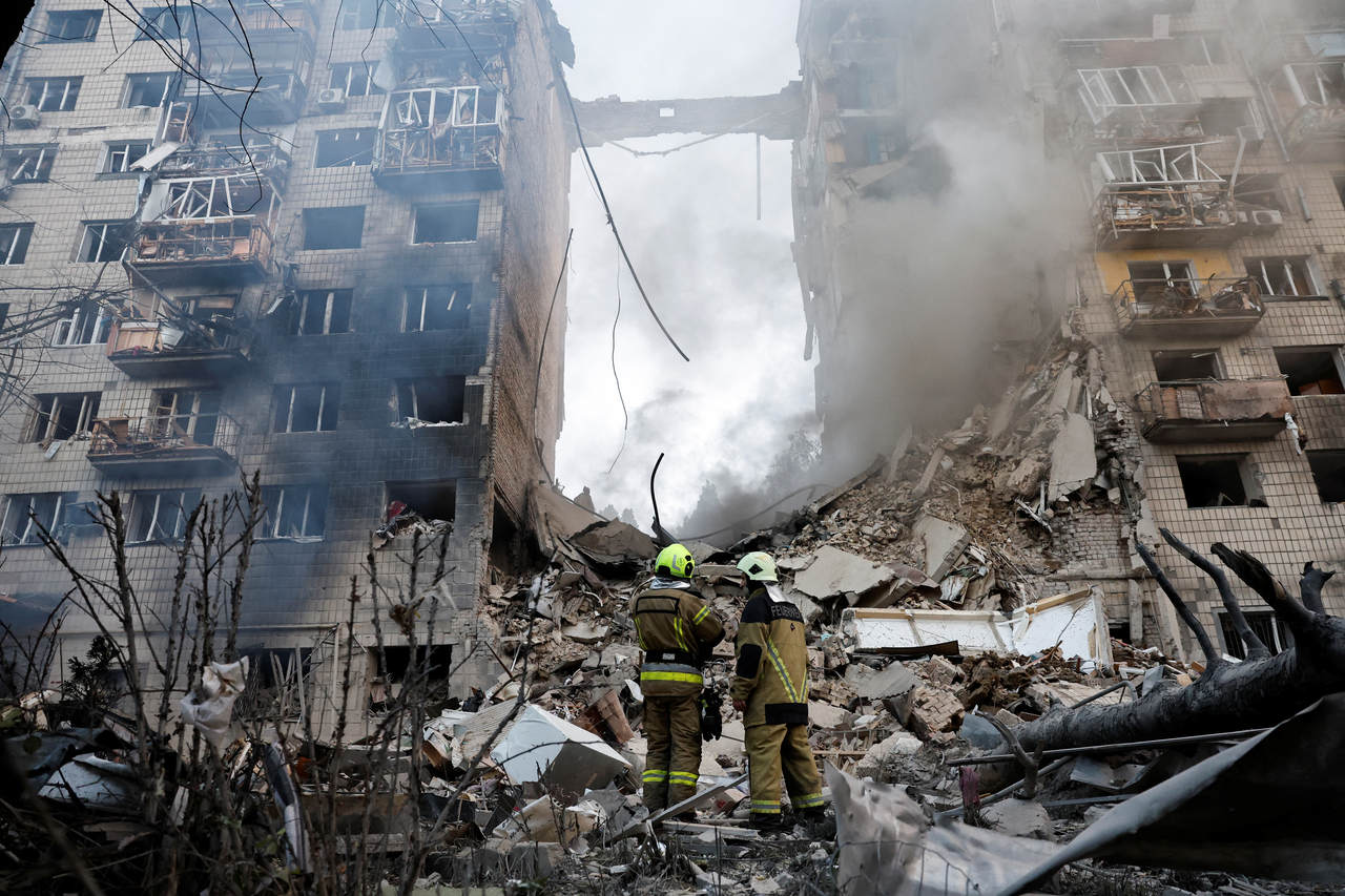 Firefighters work at the site of an apartment building damaged in Kyiv, Ukraine, Tuesday. (Reuters-Yonhap)
