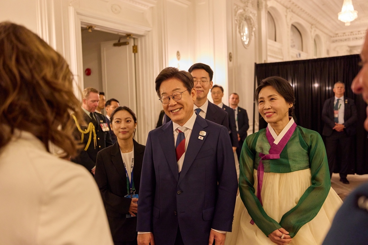 President Lee Jae Myung (center) and first lady Kim Hea Kyung (right), clad in South Korea's traditional attire, attend a reception hosted by the Governor General of Canada, Mary Simon, in Calgary, Canada, on Monday. (Pool photo via Yonhap)