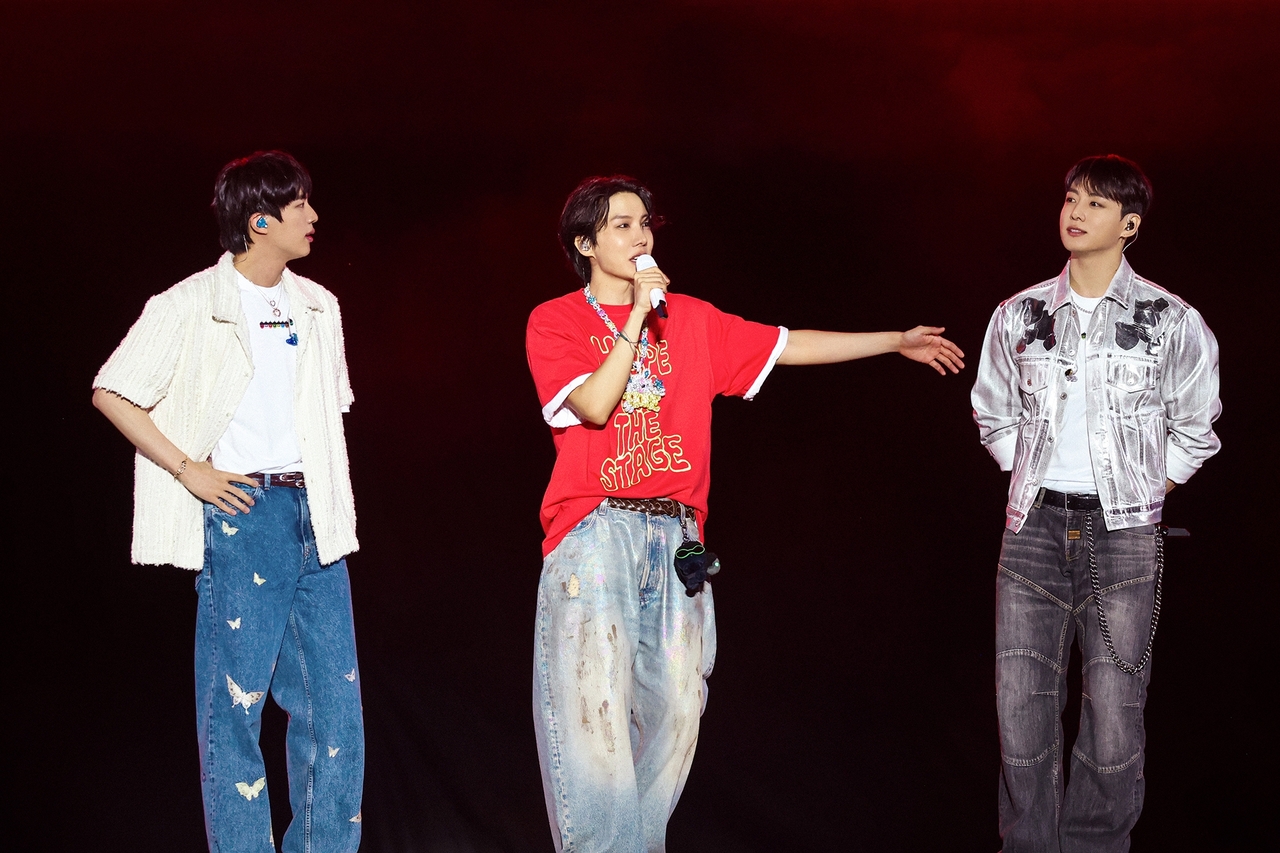 J-Hope (center) speaks to fans with Jin (left) and Jungkook during his encore solo concert "J-Hope Tour 'Hope on the Stage' Final" at Goyang Sports Complex in Gyeonggi Province on Friday. (Big Hit Music)