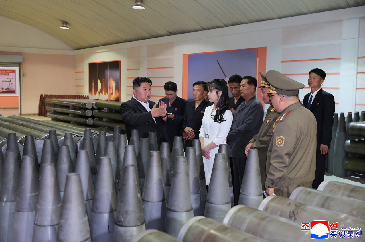 This photo, carried by North Korea's official Korean Central News Agency on June 14, 2025, shows the North's leader Kim Jong-un (left) inspecting a munitions factory the previous day to review the state of the production of artillery shells in the first half of the year. (Yonhap)