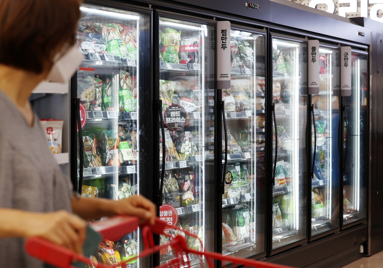 A shopper looks at the frozen food section at a large supermarket in Seoul on Friday. (Newsis)