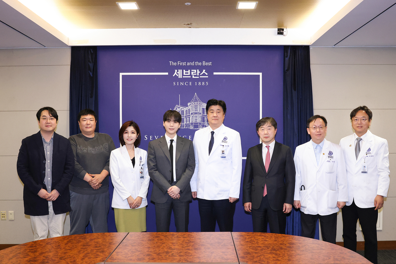 Officials of the Severance Hospital pose with K-pop superstar Suga (fourth from right) during the groundbreaking ceremony of its autism treatment center in this photo distributed Monday. (Severance Hospital)