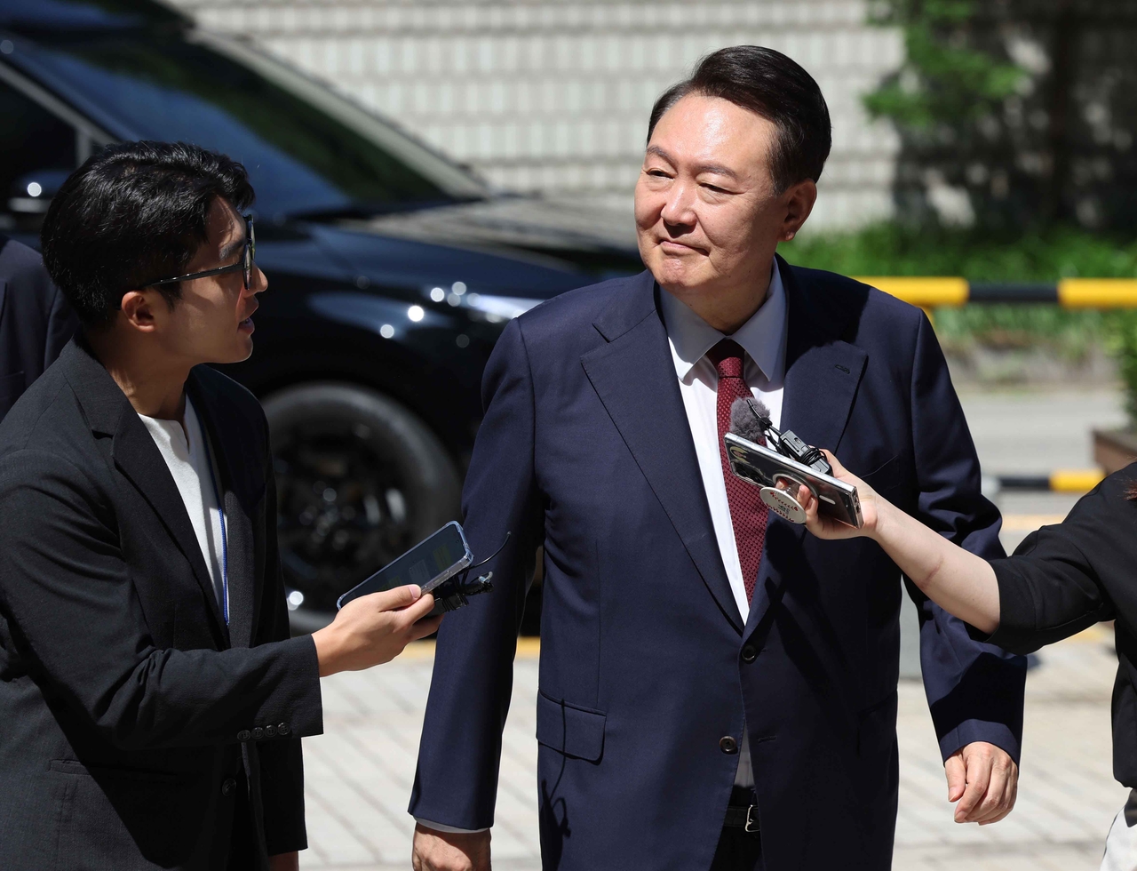 Former President Yoon Suk Yeol appears at the Seoul Central District Court on Monday to attend the eighth hearing of his trial over insurrection charges in connection with his declaration of martial law. (Yonhap)