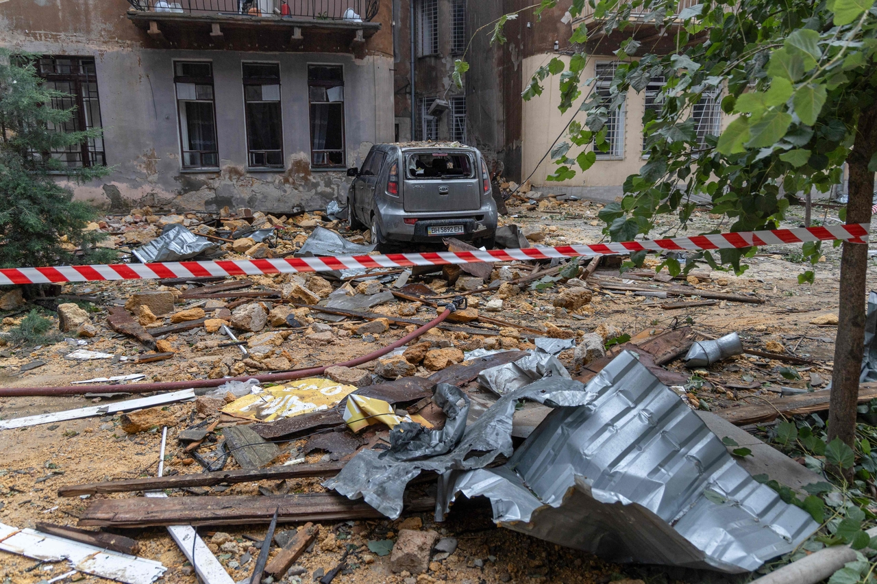 This photograph shows a damaged car in front of damaged residential buildings following the Russian drone attack in Odesa on June 20 (AFP)