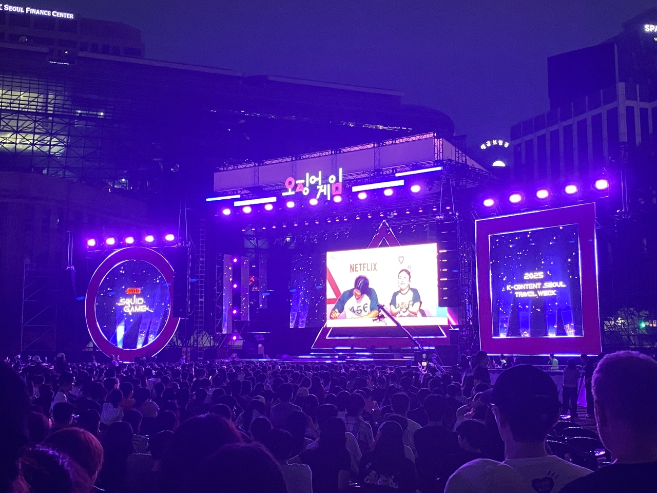 Audience are seen watching the stage of 'Squid Game' fan event held in front of Seoul City Hall, Saturday. (Lee Yoon-seo/The Korea Herald)