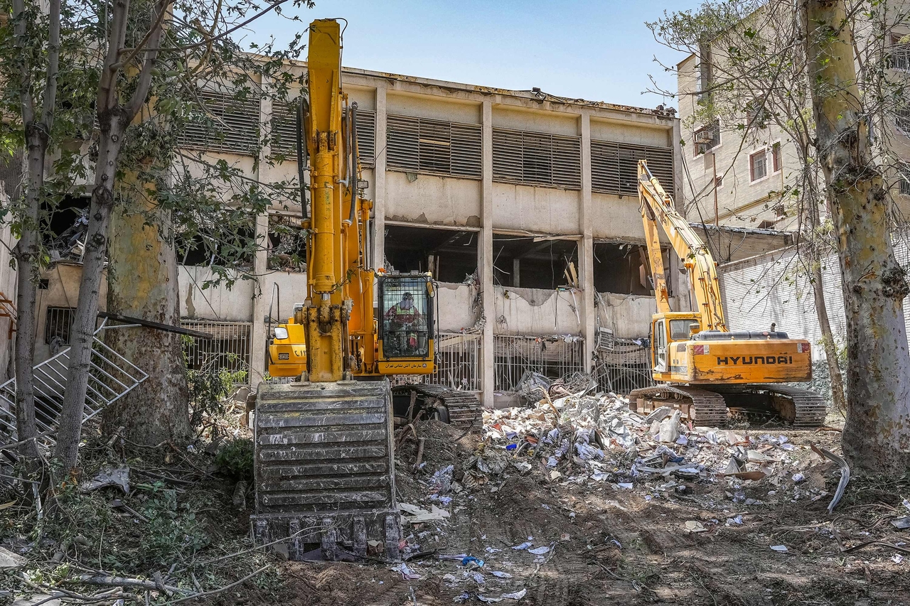 In this picture obtained from the Iranian judiciary's news agency Mizan Online on June 25, excavators are used to clear the rubble outside the Evin prison complex in Tehran that was hit days ago by an Israeli strike. An Israeli strike on Tehran's Evin prison during this month's 12-day war killed at least 71 people, Iran's judiciary said on June 29, days after a ceasefire ended hostilities between the two arch-foes. AF