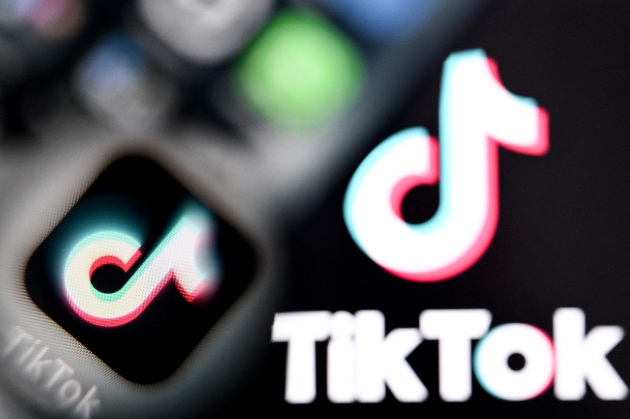 Chinese social networking service TikTok's logos on a smartphone screen (left) and laptop screen   AFP-Yonhap