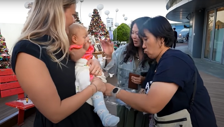 A Korean woman puts socks on Della’s baby in a video posted on her YouTube channel last month. (YouTube)