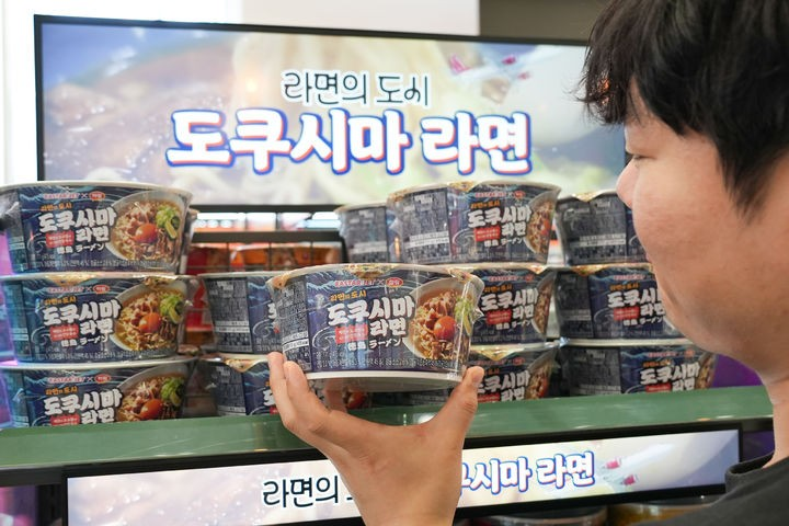 한 고객이 편의점에 진열된 도쿠시마 풀문 토토사이트 제품을 들여다보고 있다. [세븐일레븐 제공]