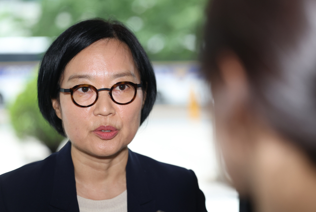 Han Sung-sook, nominee for Minister of SMEs and Startups, answers questions from reporters as she arrives at a confirmation hearing preparation office in Seoul on June 26. (Yonhap)
